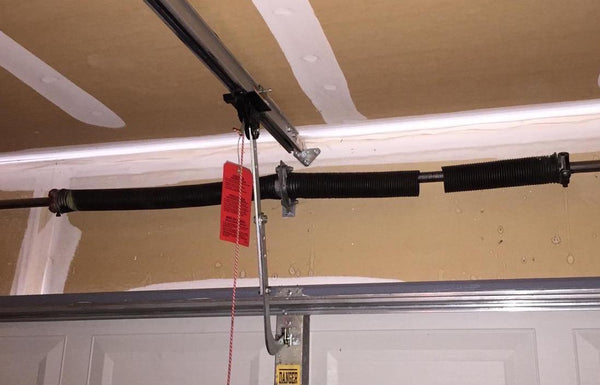 If a garage door spring breaks, should you replace both of them?